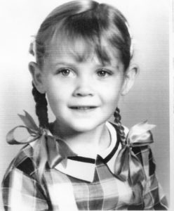 black & white photo of a very young girl, hair in braids with large ribbons tied on the end; kindergarten photo showing purity, innocence, and openness to the world. Childhood trauma can leave sacred scars and broken hearts. Reach out the The Santa Fe Therapist for emotional healing, anxiety help, low self-esteem and spiritual healing. Online therapy in Santa Fe, NM and throughout New Mexico. 87048, 87501, 87506, 87043
