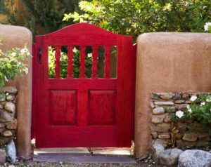 adobe wall with locked gate brightly painted red. Abode wall and entryway with locked wrought-iron gate. Don't allow low self-esteem and self-doubt to lock you out of your goals. Get help from the Santa Fe Therapist; online therapy. 87122, 87506, 87048, 87501