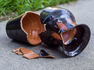 Glazed Native American pot lays on the ground, broken, symbolizing the broken heart caused by emotional trauma. Emotional health & wellbeing create tranquility and peace. The Santa Fe Therapist offers online therapy in New Mexico. 87122, 87506, 87048, 87501