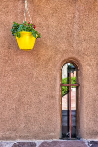 Santa Fe NM nicho, adobe wall, with a yellow flower pot; grief counseling in Santa Fe NM, feeling sad, feeling anxious, 87505
