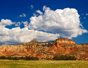 Photo of a New Mexico bluff and wide-open field with a beautiful cloud-filled blue sky. Listen to this podcast to learn how to use astrology to reduce anxiety.Emotional health and wellbeing are possible. The Santa Fe Therapist / Living From Happiness podcast with with astrologer Elizabeth Grace. Online therapy. 87506, 87048, 87544, 87122