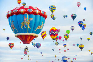 photo of Albuquerque Balloon Festival with brightly colored balloons in the air. Click here for 11 tips on how to find joy in dark times. Emotional wellbeing, spiritual therapy, grief counseling w/ the Santa Fe Therapist. Online therapy in New Mexico. 87506, 87048, 87501, 87505