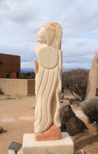 tall carved stone statue of Native American woman in Taos, New Mexico. Stress management skills can make a world of difference if you're struggling with anxiety, grief, or overwhelm. The Santa Fe Therapist can help. Online counseling. 87122, 87506, 87048, 87501