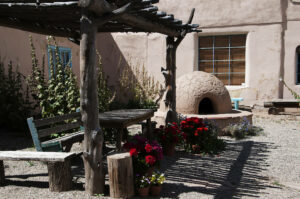 Outdoor horno (hand-made adobe oven) and rustic patio in Santa Fe, NM. If things from your childhood are haunting you, if you're struggling not-so-great relationships and don't understand why, the Santa Fe Therapist can help. Online therapy throughout New Mexico. 87505, 87508, 87506, 87574