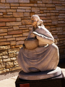 Sculpture of a woman sitting in front of a natural stone dry-stack wall in northern New Mexico. The disowned parts of yourself can cause intrusive, negative thoughts, catastrophizing, and contribute to anxiety and depression. The Santa Fe Therapist can help you regain your emotional wellbeing using IFS and Parts therapy. The Santa Fe Therapist is here to help you move into your future. Online therapy in New Mexico. 87506, 87048, 87501, 87505